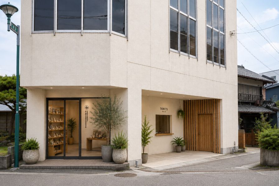 The building after renovation, with a glass
          entrance and plants