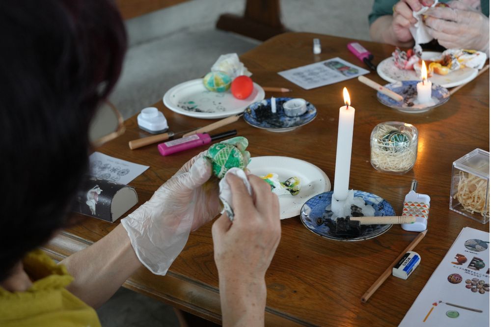 Hands decorating an egg at a pysanka workshop